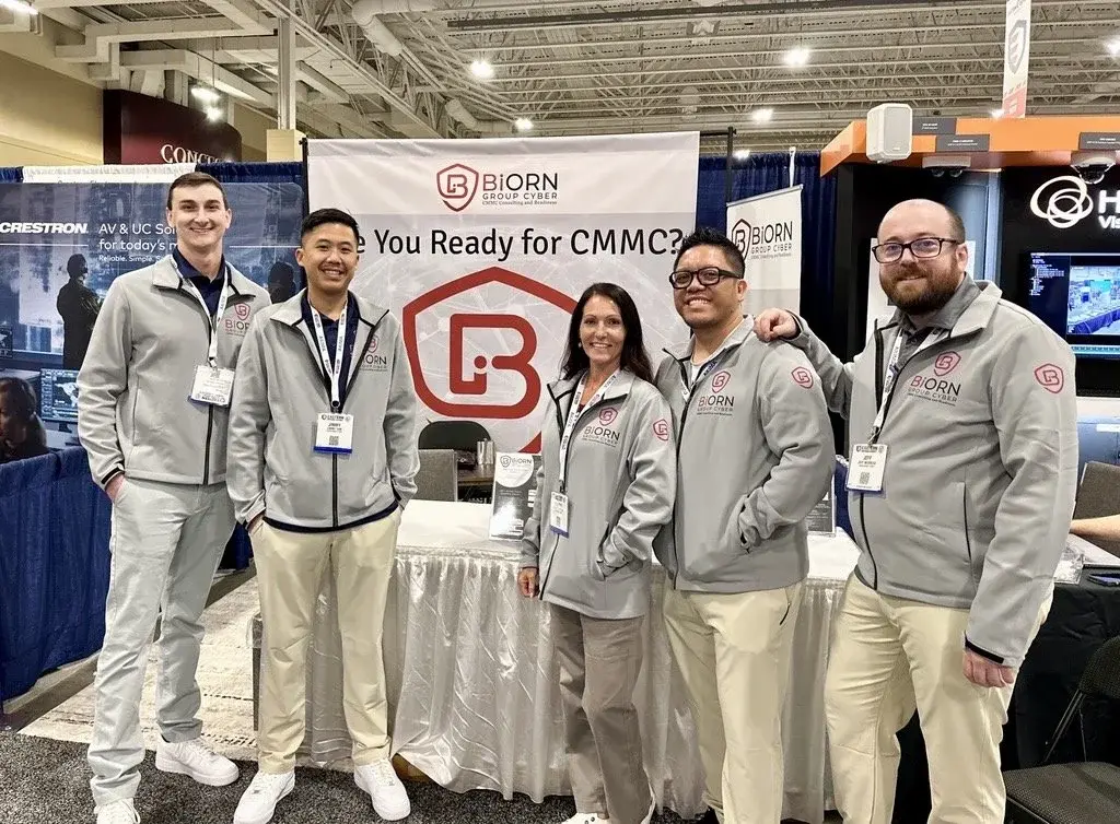 Biorn Group Cyber team members standing together at a cybersecurity conference booth.